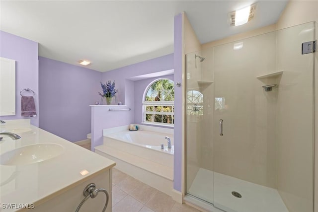 full bathroom with a garden tub, tile patterned flooring, toilet, a sink, and a stall shower