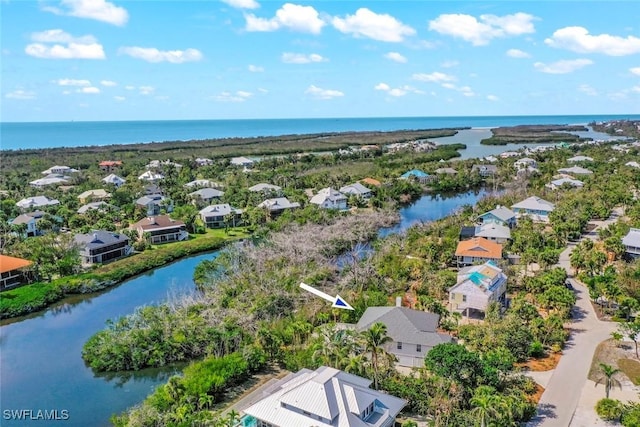 drone / aerial view with a water view and a residential view