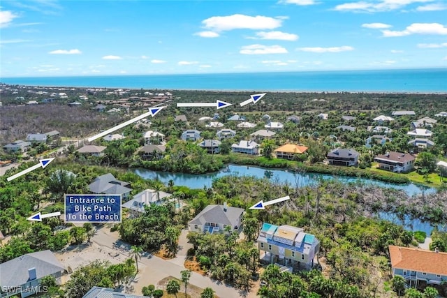 birds eye view of property with a water view and a residential view