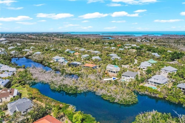 drone / aerial view featuring a water view and a residential view