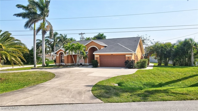 view of front of house with stucco siding, a front yard, an attached garage, and driveway