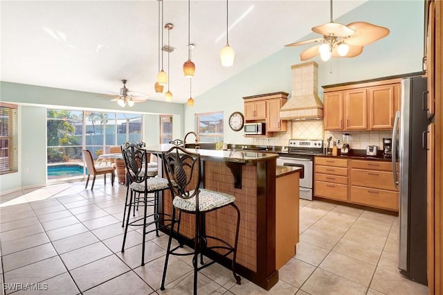 kitchen with custom range hood, tasteful backsplash, appliances with stainless steel finishes, a breakfast bar area, and light tile patterned floors