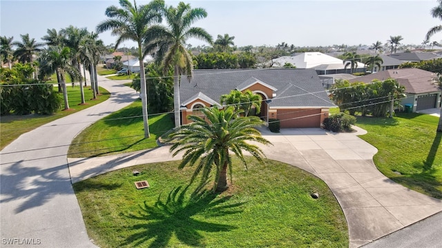 view of front of house with a front yard, fence, driveway, a garage, and a residential view