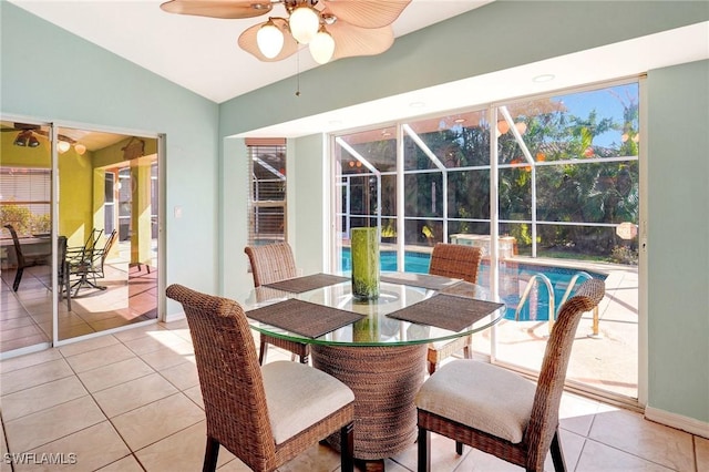 dining space featuring lofted ceiling, light tile patterned floors, a sunroom, and ceiling fan