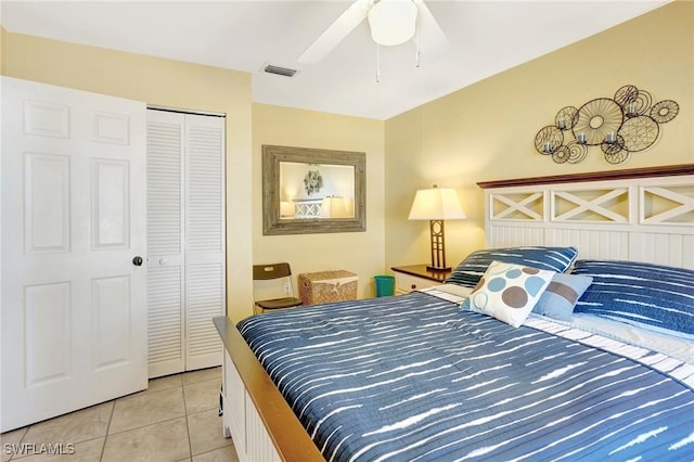 bedroom featuring light tile patterned floors, visible vents, a closet, and ceiling fan