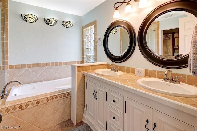 bathroom with a sink, a garden tub, double vanity, and tile patterned floors