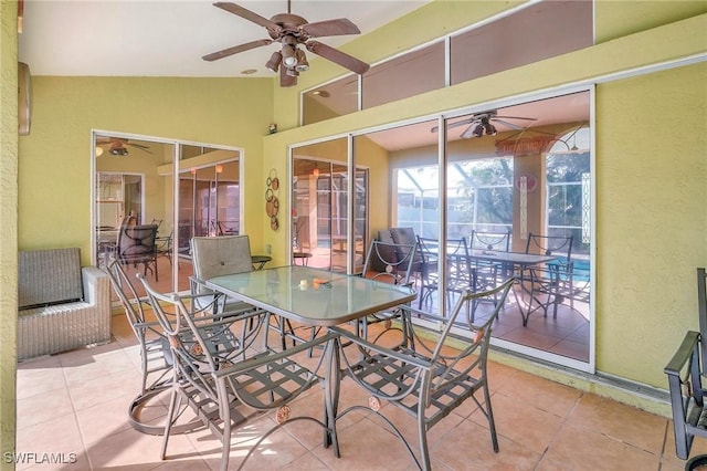 sunroom with lofted ceiling and ceiling fan