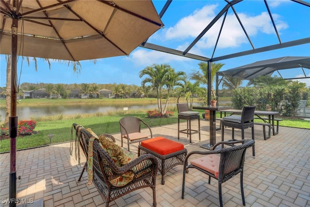 view of patio / terrace with a lanai and a water view