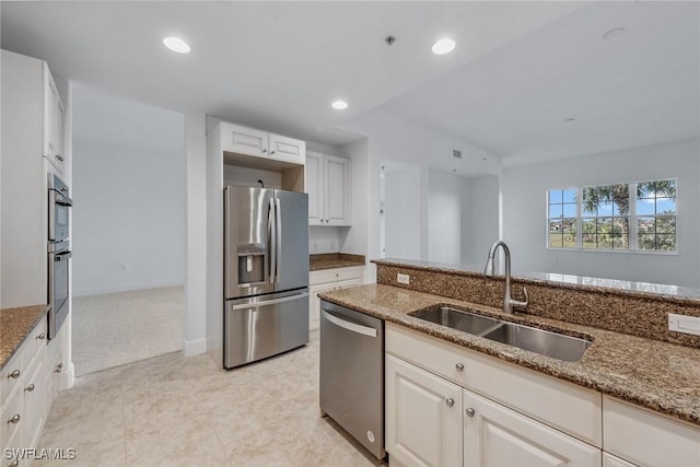 kitchen featuring white cabinetry, stainless steel appliances, sink, and light stone counters