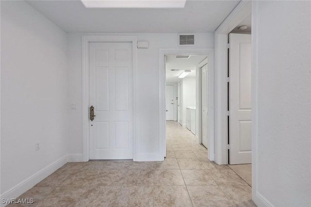 hallway featuring light tile patterned floors