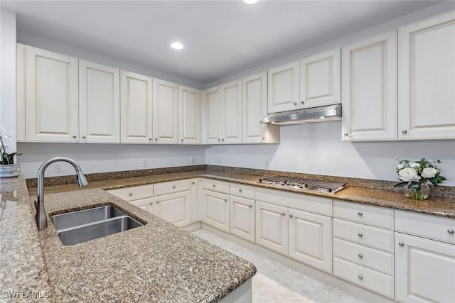 kitchen with stainless steel gas stovetop, stone countertops, sink, and white cabinets