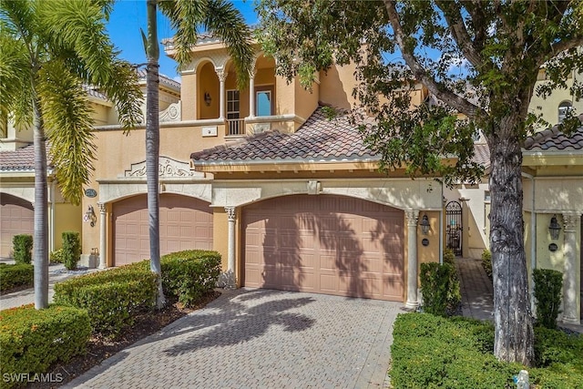 mediterranean / spanish home with a garage