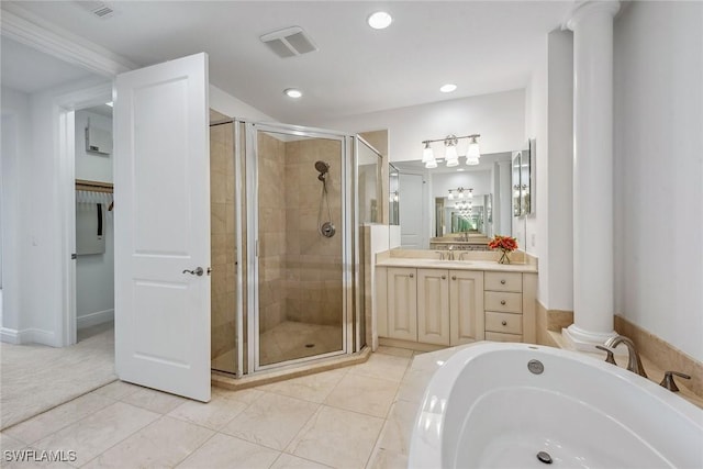 bathroom with ornate columns, plus walk in shower, vanity, and tile patterned floors