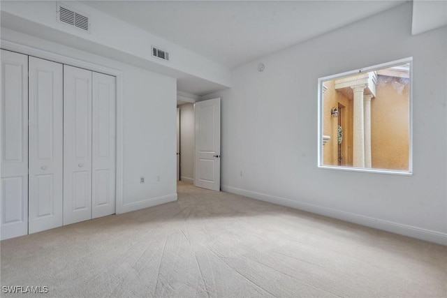 unfurnished bedroom featuring carpet floors and a closet