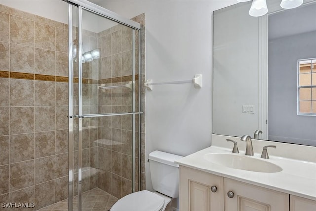 bathroom featuring vanity, toilet, and walk in shower