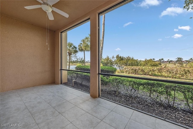 unfurnished sunroom featuring ceiling fan