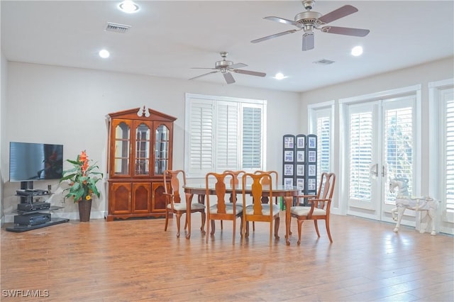 dining area with french doors, ceiling fan, and light wood-type flooring