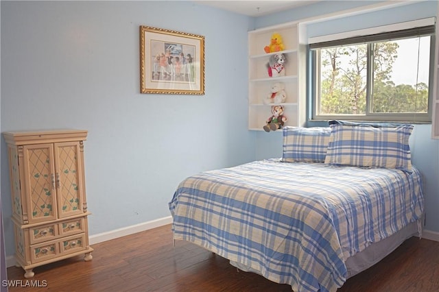 bedroom with dark wood-type flooring