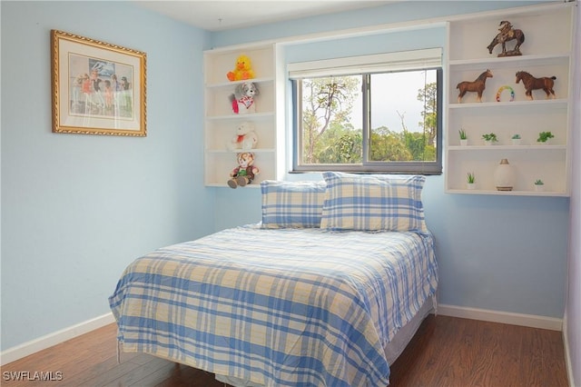 bedroom with dark hardwood / wood-style floors