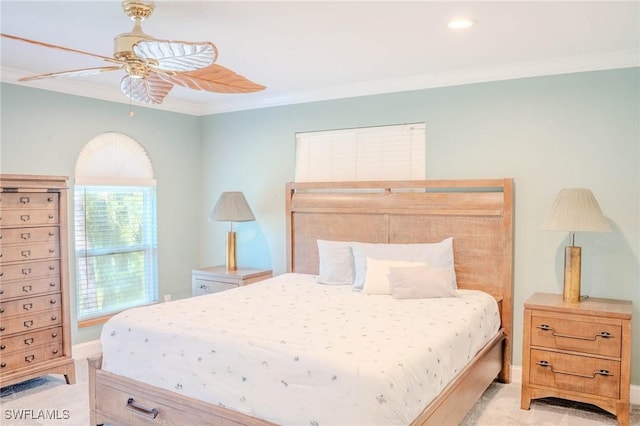 carpeted bedroom with crown molding and ceiling fan