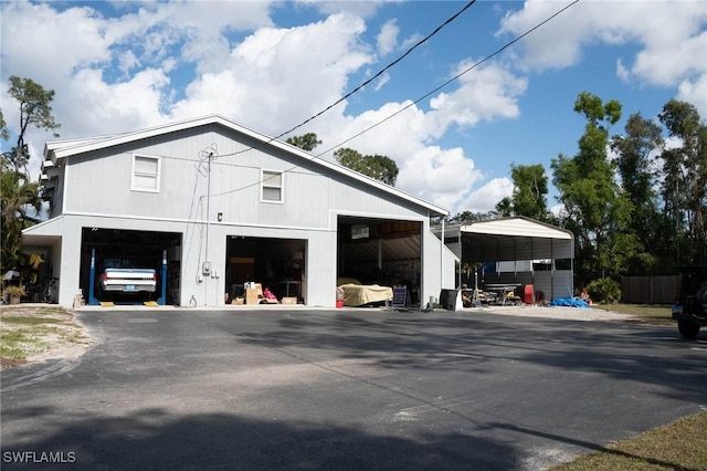 exterior space with a carport and a garage