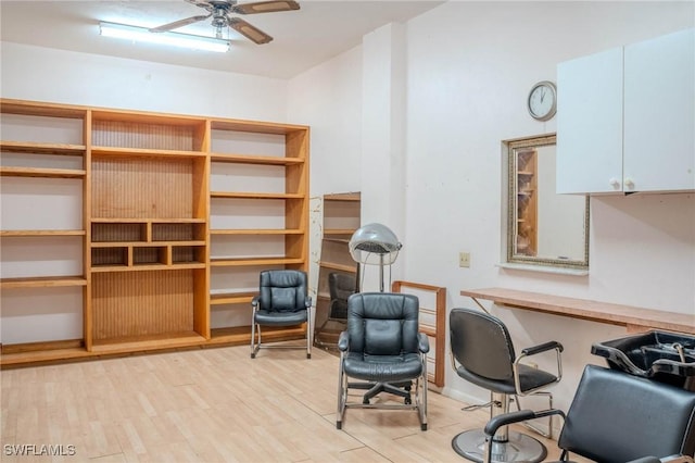 sitting room with ceiling fan and light wood-type flooring