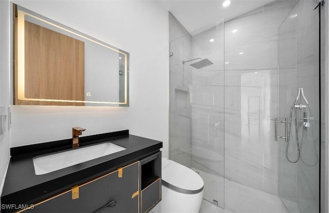 bathroom with vanity, a shower with shower door, and toilet