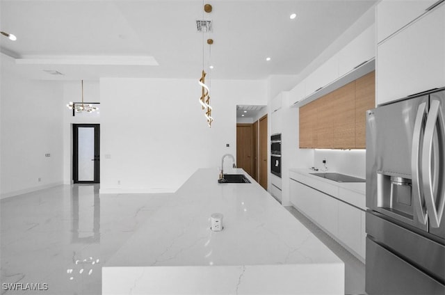 kitchen featuring white cabinetry, sink, hanging light fixtures, light stone counters, and stainless steel refrigerator with ice dispenser