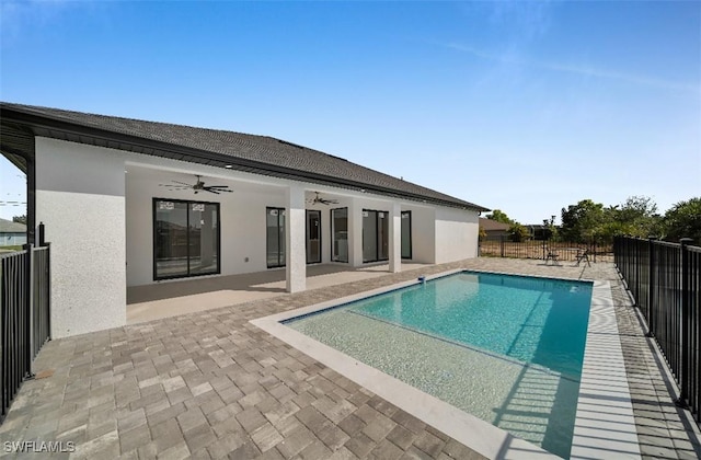 view of swimming pool featuring ceiling fan and a patio