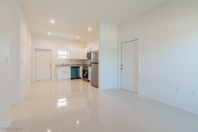 kitchen with recessed lighting, white cabinetry, baseboards, light countertops, and appliances with stainless steel finishes