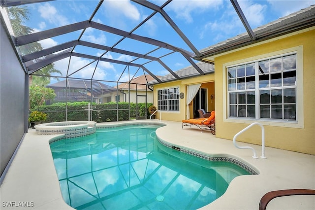 view of pool featuring a lanai, a patio area, and an in ground hot tub