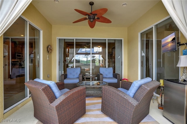 view of patio featuring ceiling fan and outdoor lounge area