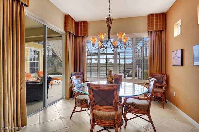 tiled dining area with an inviting chandelier