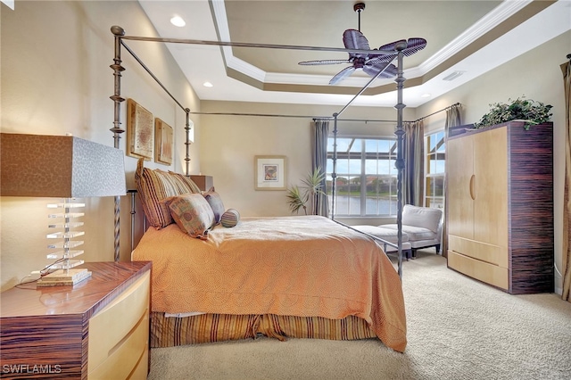 bedroom featuring ornamental molding, carpet flooring, and a tray ceiling