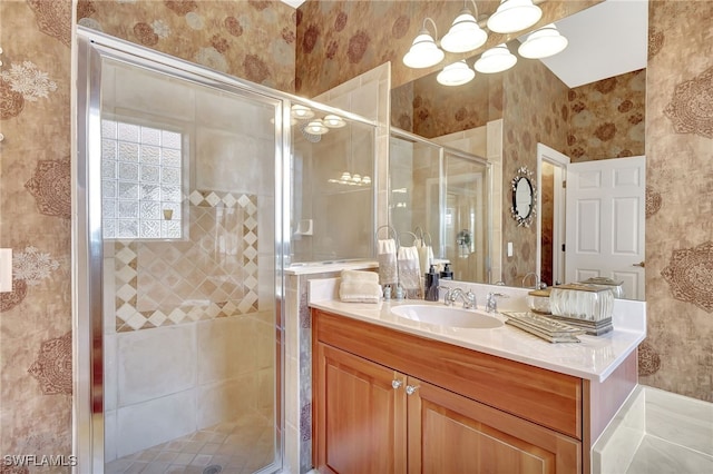 bathroom featuring vanity and a shower with shower door