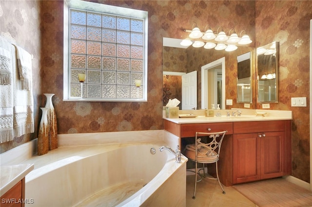 bathroom featuring vanity, tile patterned flooring, and a tub