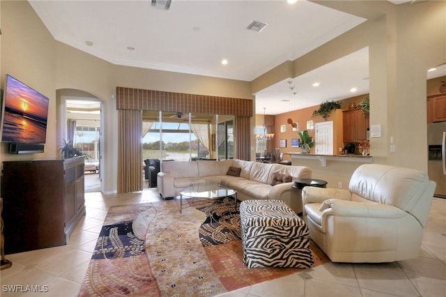 living room featuring light tile patterned flooring and ornamental molding