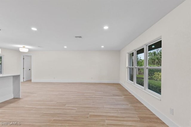 spare room with light wood-type flooring