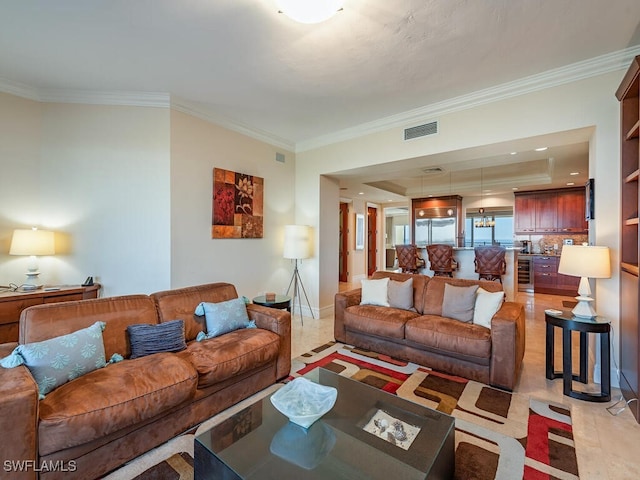 living room featuring a tray ceiling, light tile patterned floors, crown molding, and wine cooler