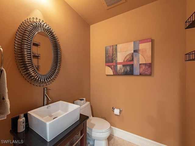 bathroom featuring vanity, toilet, and tile patterned flooring