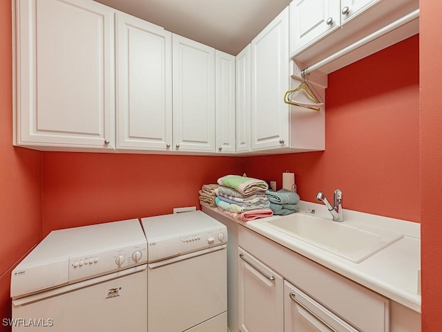 laundry area featuring cabinets, sink, and washing machine and clothes dryer