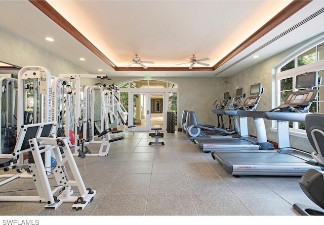 workout area with french doors, ceiling fan, and a tray ceiling