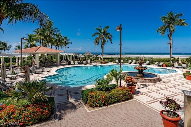 view of swimming pool featuring a gazebo, a water view, and a patio