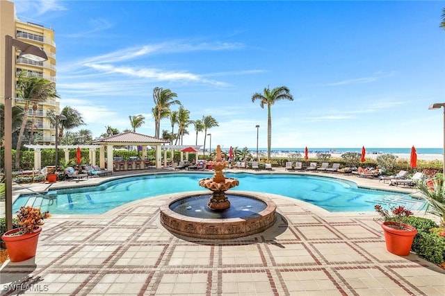 view of swimming pool featuring a gazebo and a water view