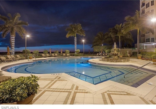 pool at night with a patio