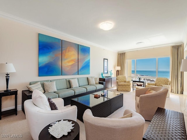 living room featuring ornamental molding, a water view, and a beach view