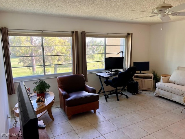 tiled office space with ceiling fan and a textured ceiling