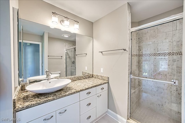 bathroom featuring vanity and an enclosed shower