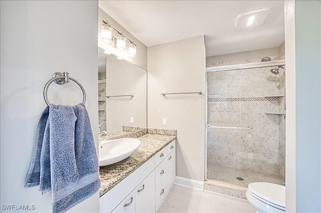 bathroom featuring vanity, toilet, and an enclosed shower