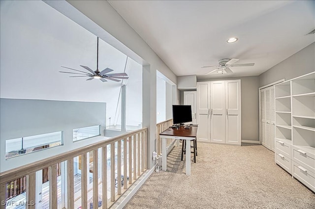 home office featuring ceiling fan and light colored carpet